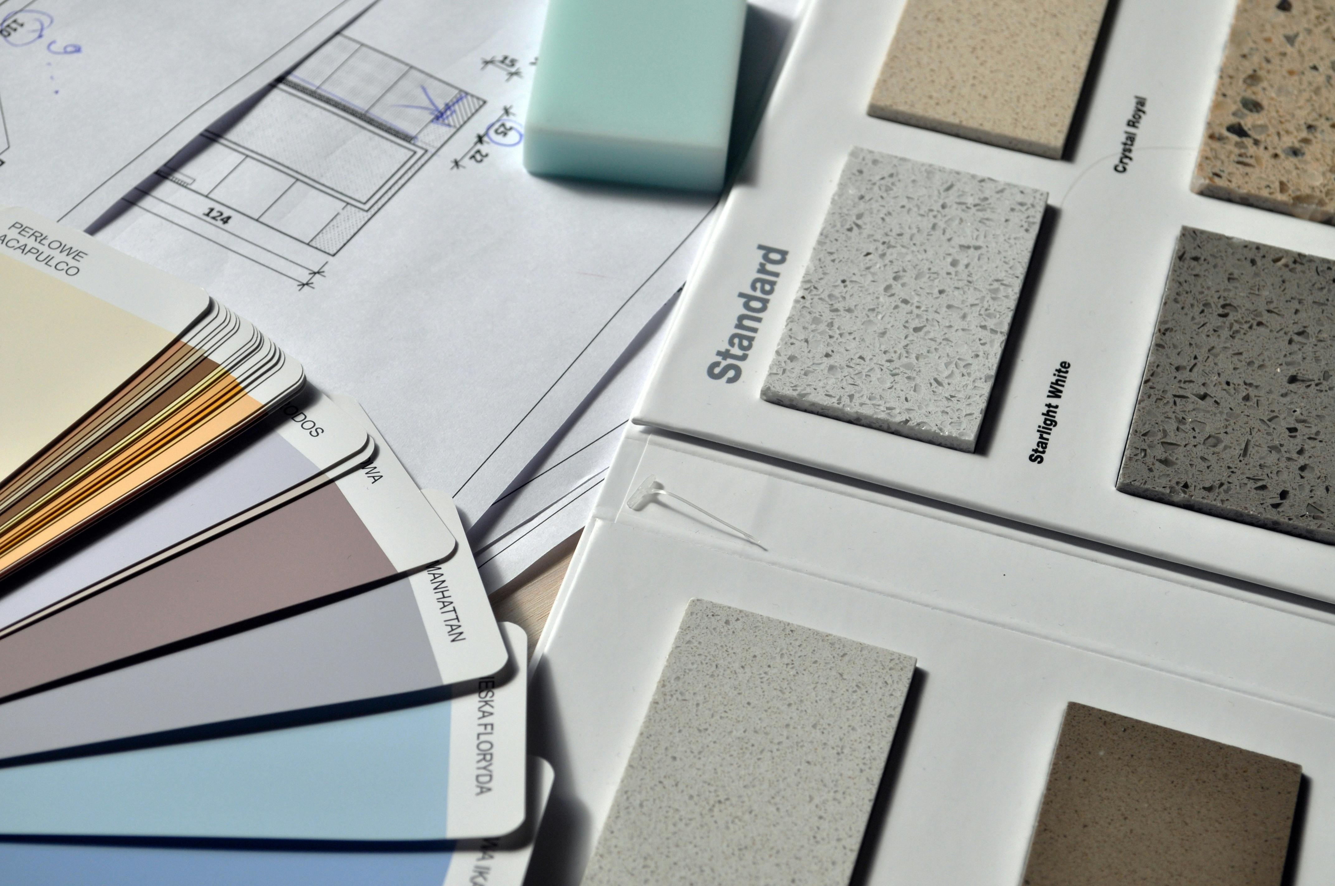 Brand-Approved Design Experts for Hotels Color palette and material samples for interior renovation projects on a blueprint.